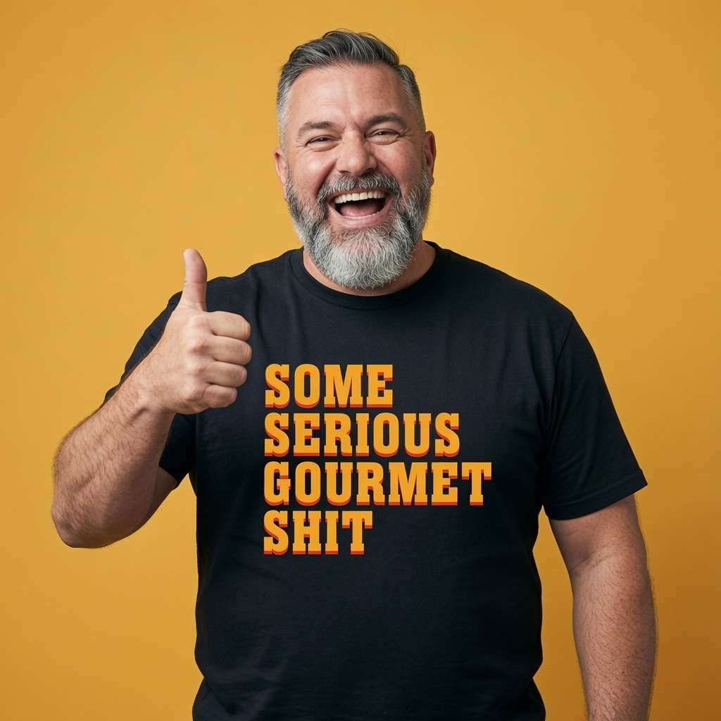 Bearded man laughing and giving a thumbs up while wearing a black Some Serious Gourmet Shit t-shirt, witty and funny mens movie text full of pure attitude