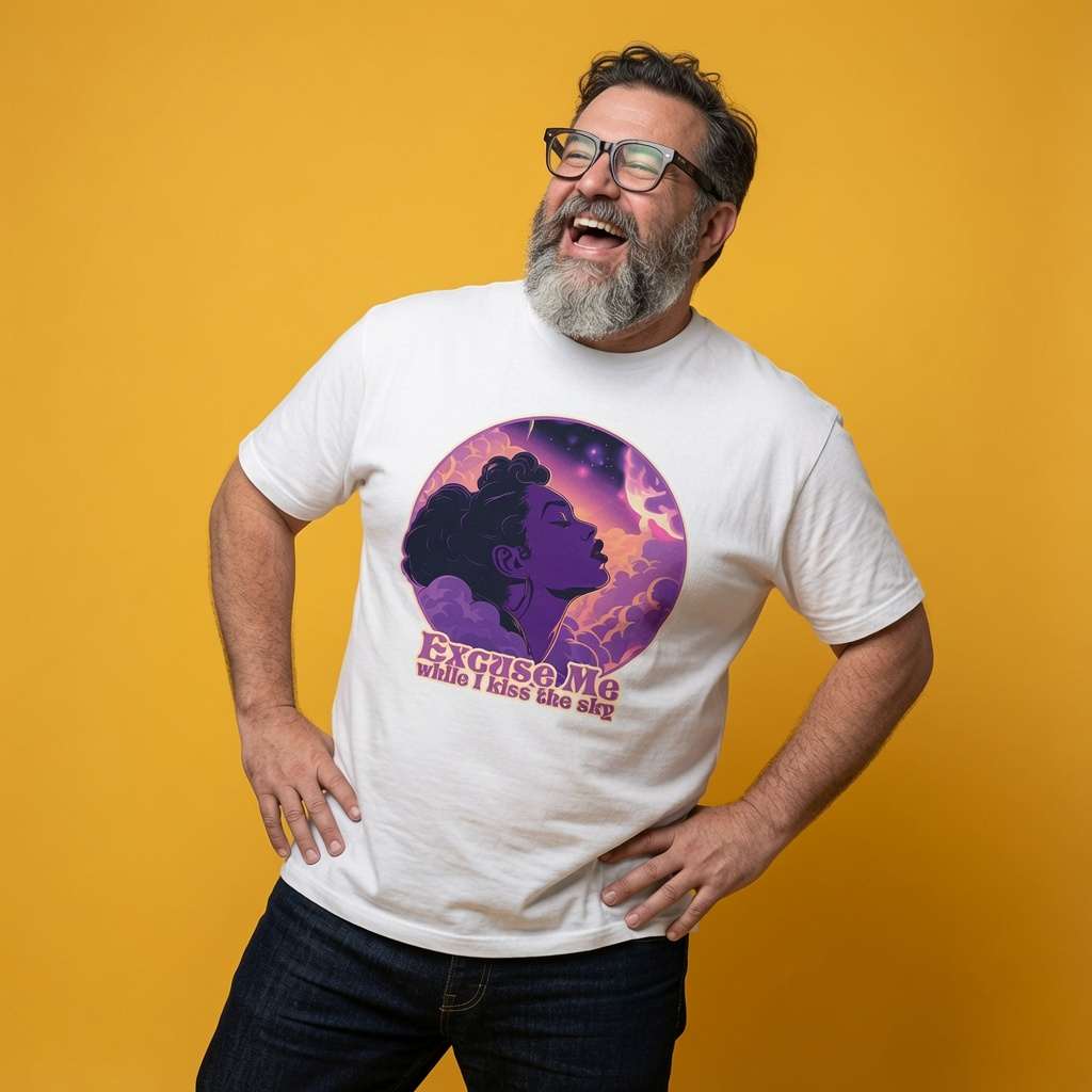 Bearded man with glasses laughing with hands on his hips while wearing a white Excuse Me While I Kiss the Sky t-shirt featuring a purple silhouette against a cosmic background, mens 70s music-inspired purple graphic