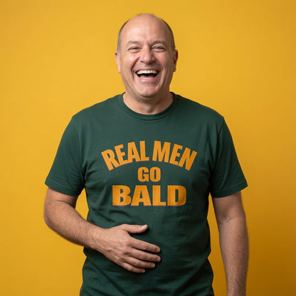 Man laughing while wearing a green Real Men Go Bald t-shirt, funny mens witty fathers day gift design that every cheeky lad will claim