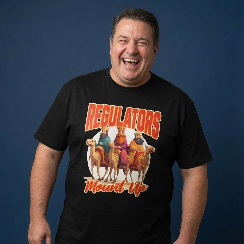 Man laughing while wearing a black Regulators Mount Up t-shirt, funny xmas banter graphic full of pure festive energy