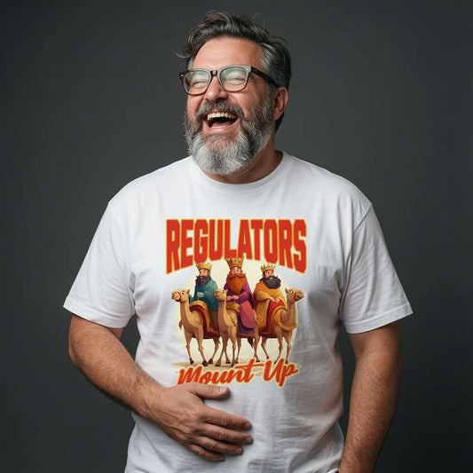 Bearded man with glasses laughing with one hand on his stomach in a white Regulators Mount Up t-shirt, funny and witty Christmas banter graphic that every wise man will claim
