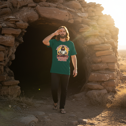 Man wearing a green t-shirt with a graphic design, standing in front of a stone structure.