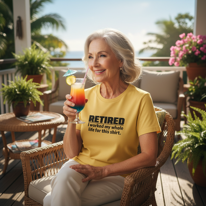 Woman sitting on a patio holding a colorful drink, wearing a yellow t-shirt with text.