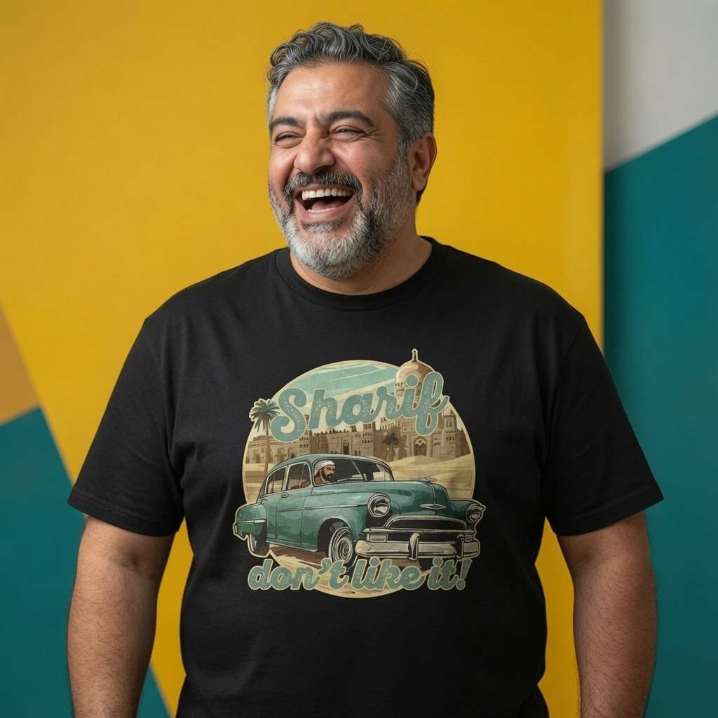 Man laughing while wearing a black Sharif Don’t Like It! t-shirt, funny mens vintage music inspired design full of pure attitude