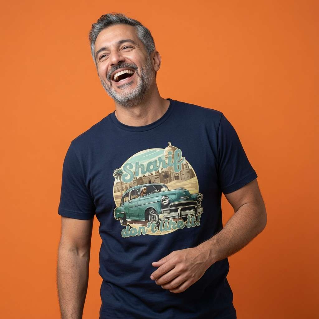 Man laughing with one hand near his stomach while wearing a navy Sharif Don’t Like It! t-shirt, fun mens 80s music inspired graphic design that every cheeky lad will claim