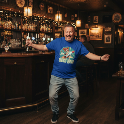 Man in a blue t-shirt standing in a bar with shelves of bottles and framed pictures on the wall.