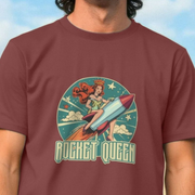 Maroon cool music t-shirt with 'Rocket Queen' graphic design featuring a woman sat riding on a rocket.