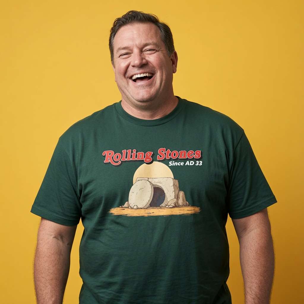 Man laughing while wearing a green Rolling Stones Since AD 33 t-shirt, witty offensive mens religious banter design full of pure attitude