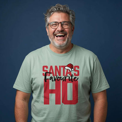 Bearded man with glasses laughing in an aloe green Santa’s Favourite HO t-shirt, fun mens witty Christmas banter slogan that every favourite HO will claim