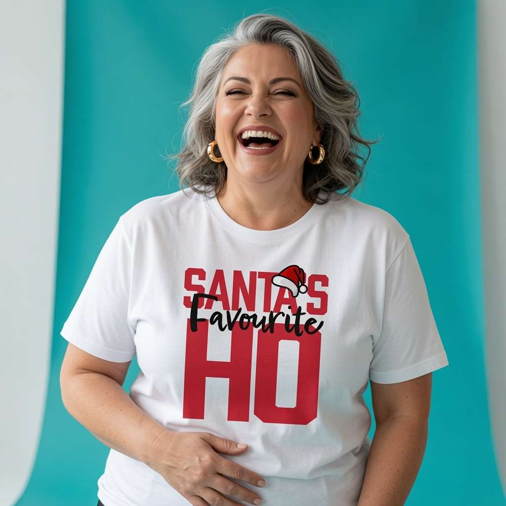 Woman laughing with one hand on her stomach while wearing a white Santa’s Favourite HO t-shirt, cheeky funny ladies xmas gift design full of pure attitude