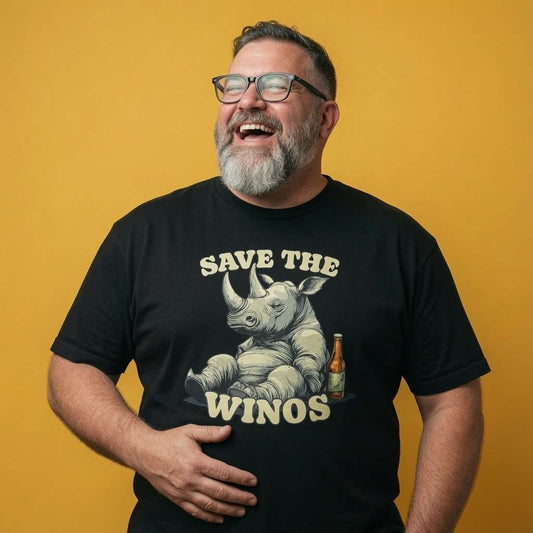 Bearded man with glasses laughing with one hand on his stomach while wearing a black Save the Winos t-shirt, fun mens witty rhino pun graphic full of pure attitude