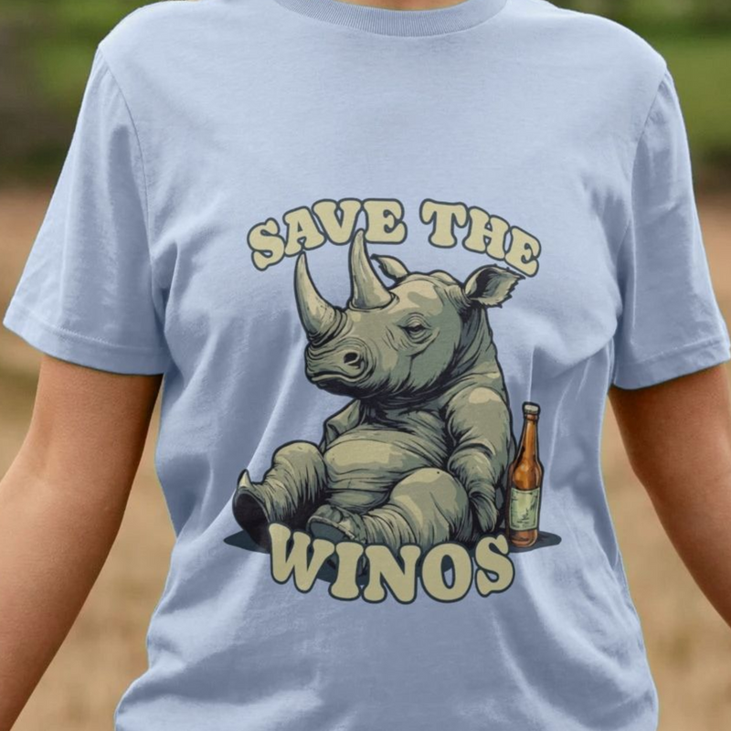 Light blue animal t-shirt with a rhino graphic and the funny slogan 'Save the Winos'  on a blurred natural background