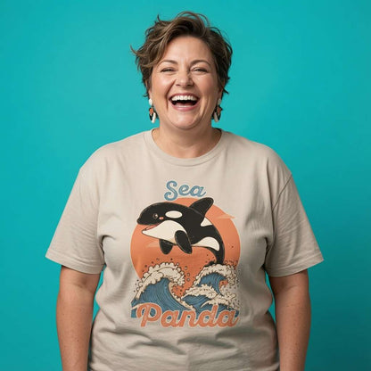 Woman laughing while wearing a beige Sea Panda t-shirt, funny ladies cheeky orca pun graphic design full of pure attitude