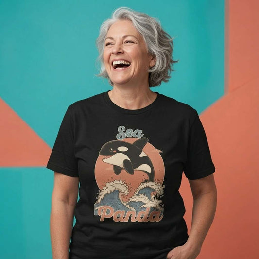 Woman laughing while wearing a black Sea Panda t-shirt, witty ladies fun orca whale graphic design full of pure attitude