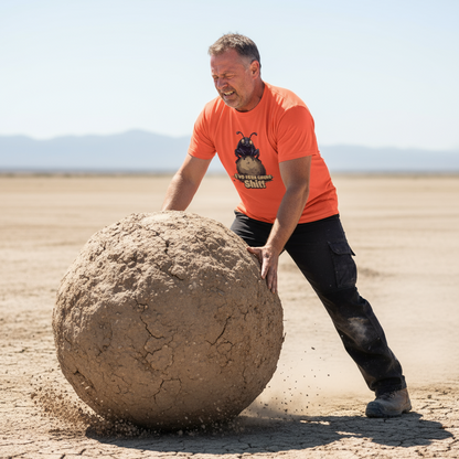 Man pushing a large spherical rock in a desert landscape