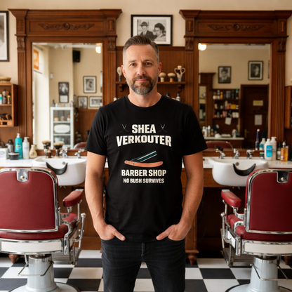 Man wearing a black t-shirt with 'Shea Verkouter Barber Shop' text in a vintage barber shop setting.