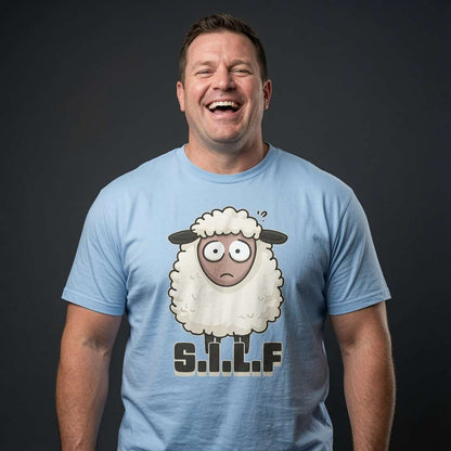 Man laughing while wearing a light blue S.I.L.F t-shirt featuring a wide-eyed cartoon sheep, witty mens funny sheep pun graphic