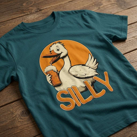 Teal Silly Goose t-shirt laid flat on a wooden surface showing the complete goose and beer graphic, funny and cheeky ladies goose pun design that every drinking lady will claim