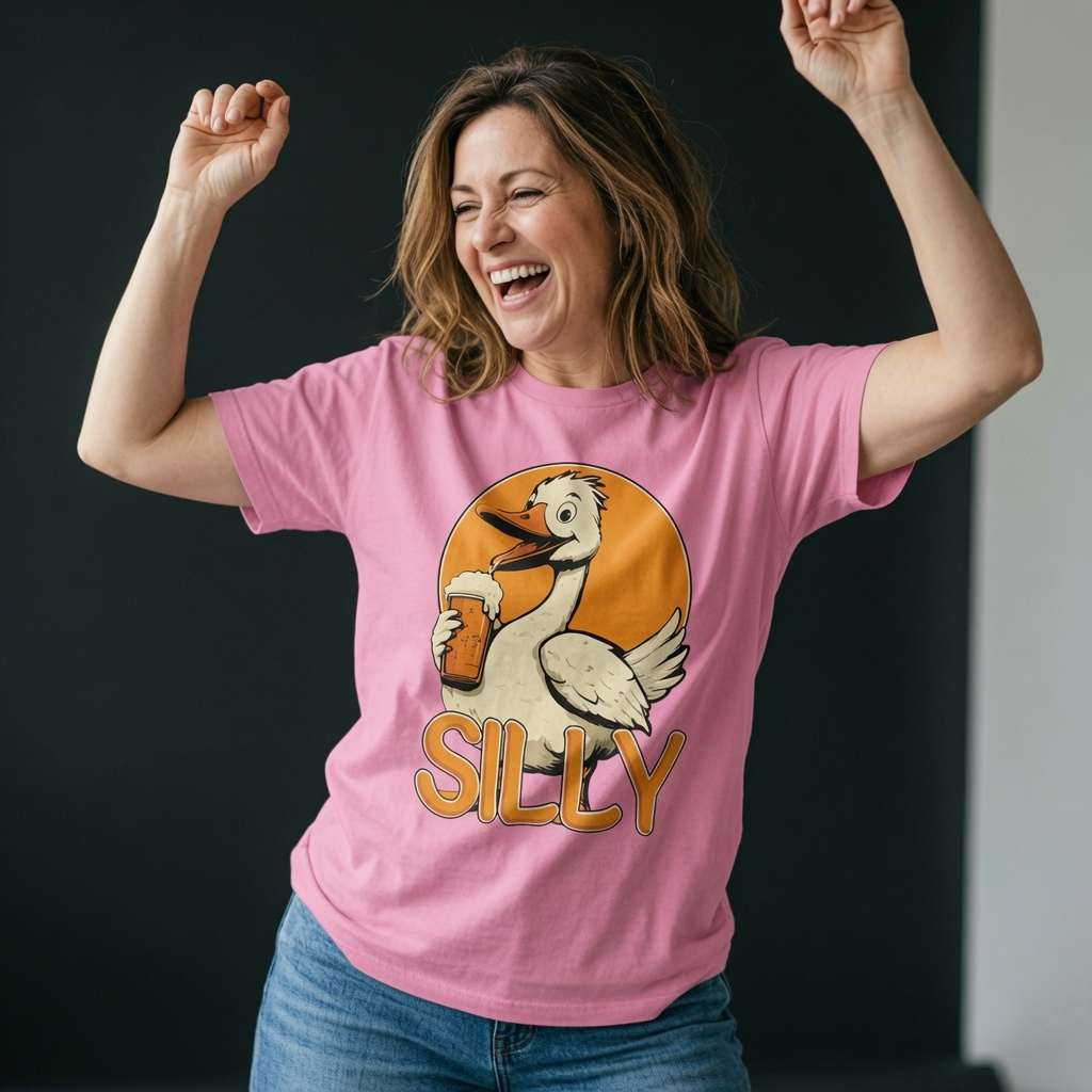 Woman laughing with both arms raised while wearing a pink Silly Goose t-shirt featuring a cartoon goose holding a pint of beer, witty ladies funny goose pun graphic
