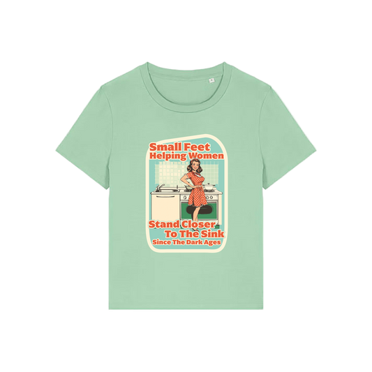 green funny offensive t-shirt with the graphic of a retro housewife and the slogan 'small feet helping women stand closer to the sink since the dark ages'