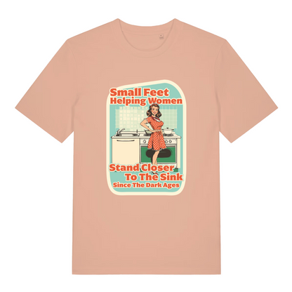peach women's funny offensive t-shirt with the graphic of a retro housewife stood in a kitchen and the slogan 'small feet helping women stand closer to the sink since the dark ages'