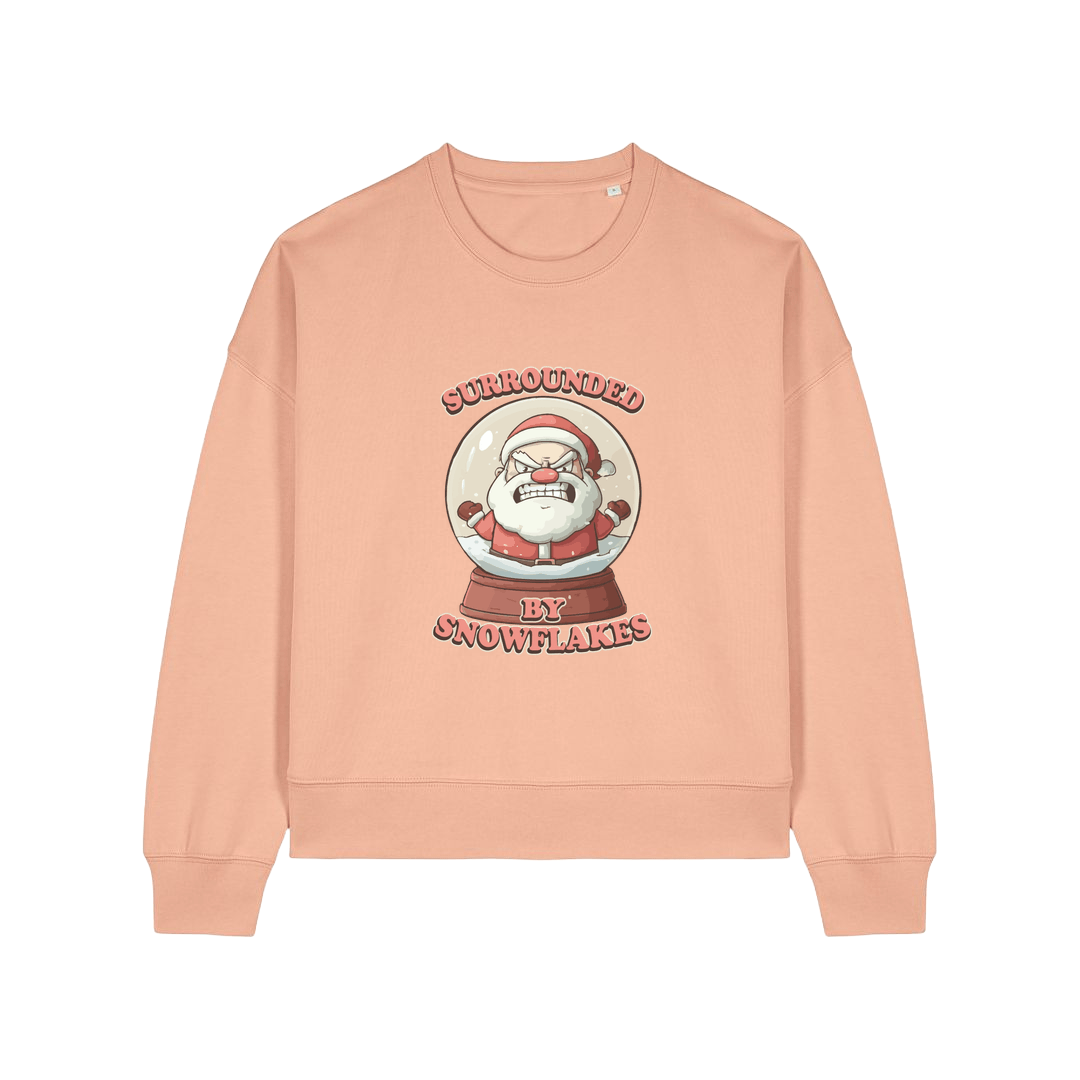 peach christmas sweater with the graphic of santa inside a snowglobe and the slogan 'surrounded by snowflakes'