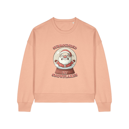 peach christmas sweater with the graphic of santa inside a snowglobe and the slogan 'surrounded by snowflakes'