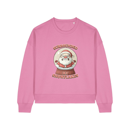pink christmas sweater with the graphic of santa inside a snowglobe and the slogan 'surrounded by snowflakes'