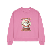 pink christmas sweater with the graphic of santa inside a snowglobe and the slogan 'surrounded by snowflakes'