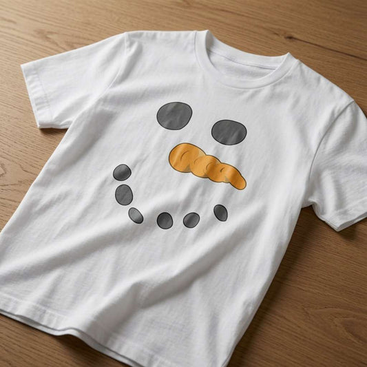 White Snowman Face t-shirt laid flat on a wooden surface showing the full coal eyes, carrot nose and smile graphic, funny mens festive costume design that every cheeky lad will claim