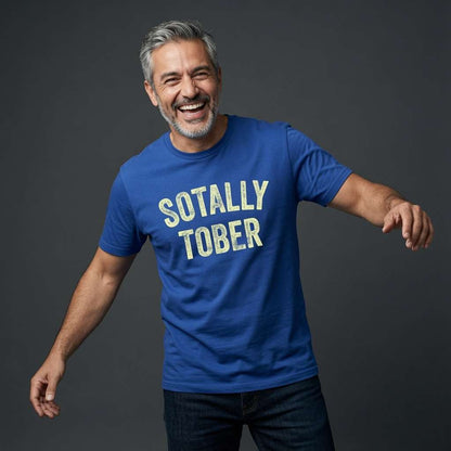 Grey-haired man laughing with arms slightly out in a blue Sotally Tober t-shirt, witty mens funny pub banter that every drinking lad will claim