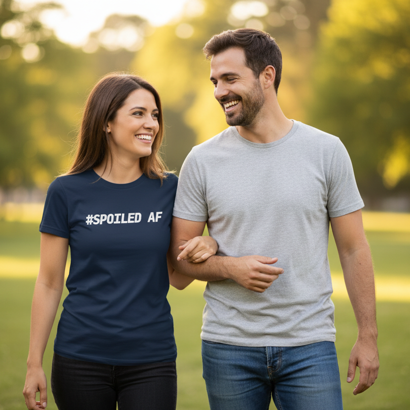 Man and woman walking together in a park with the woman wearing a '#SPOILED AF' shirt.
