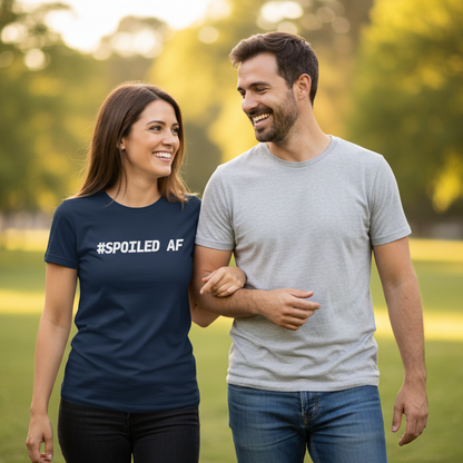 Man and woman walking together in a park with the woman wearing a '#SPOILED AF' shirt.