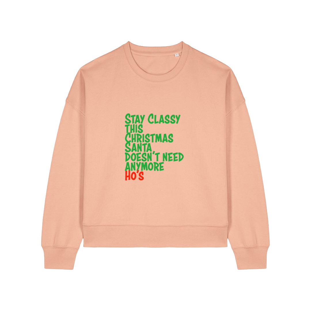 peach christmas sweater with the slogan 'stay classy this christmas santa doesn't need anymore ho's'