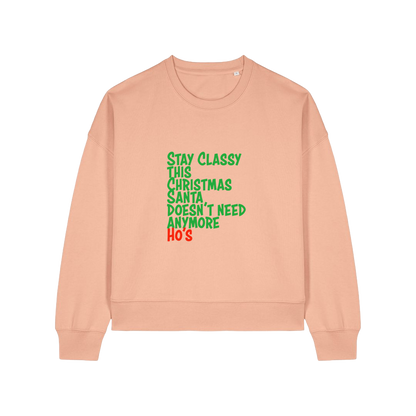 peach christmas sweater with the slogan 'stay classy this christmas santa doesn't need anymore ho's'