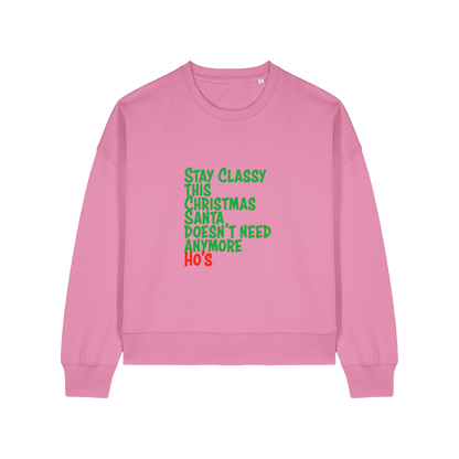 pink christmas sweater with the slogan 'stay classy this christmas santa doesn't need anymore ho's'