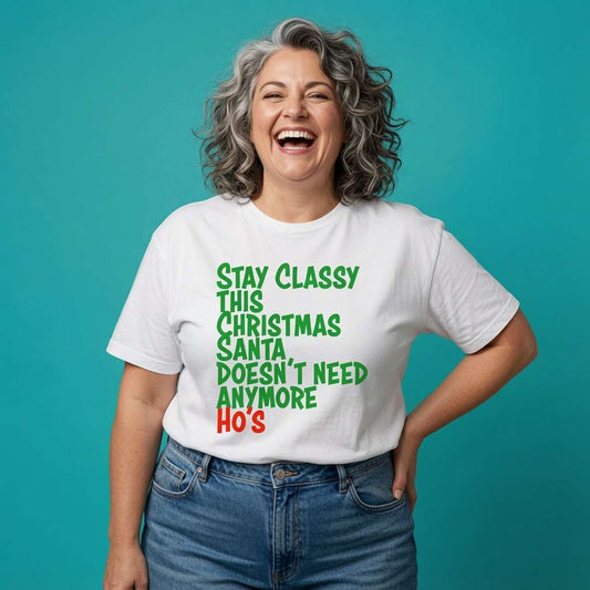 Woman laughing with one hand on her hip in a white Stay Classy This Christmas Santa Doesn’t Need Anymore Ho’s t-shirt, hilarious ladies Christmas witty slogan shirt full of pure attitude