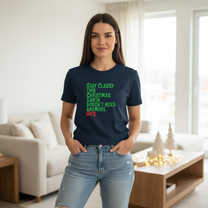 Woman wearing a navy blue t-shirt with green text in a living room.