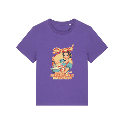 purple retro t-shirt with the graphic of a retro housewife and the slogan 'stressed is desserts spelled backwards'