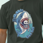 Black funny shark t-shirt with a tattoo style graphic design of a shark and skeleton, text 'talk shit get bit', on a light blue background.