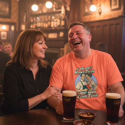 Man and woman laughing together in a bar with drinks