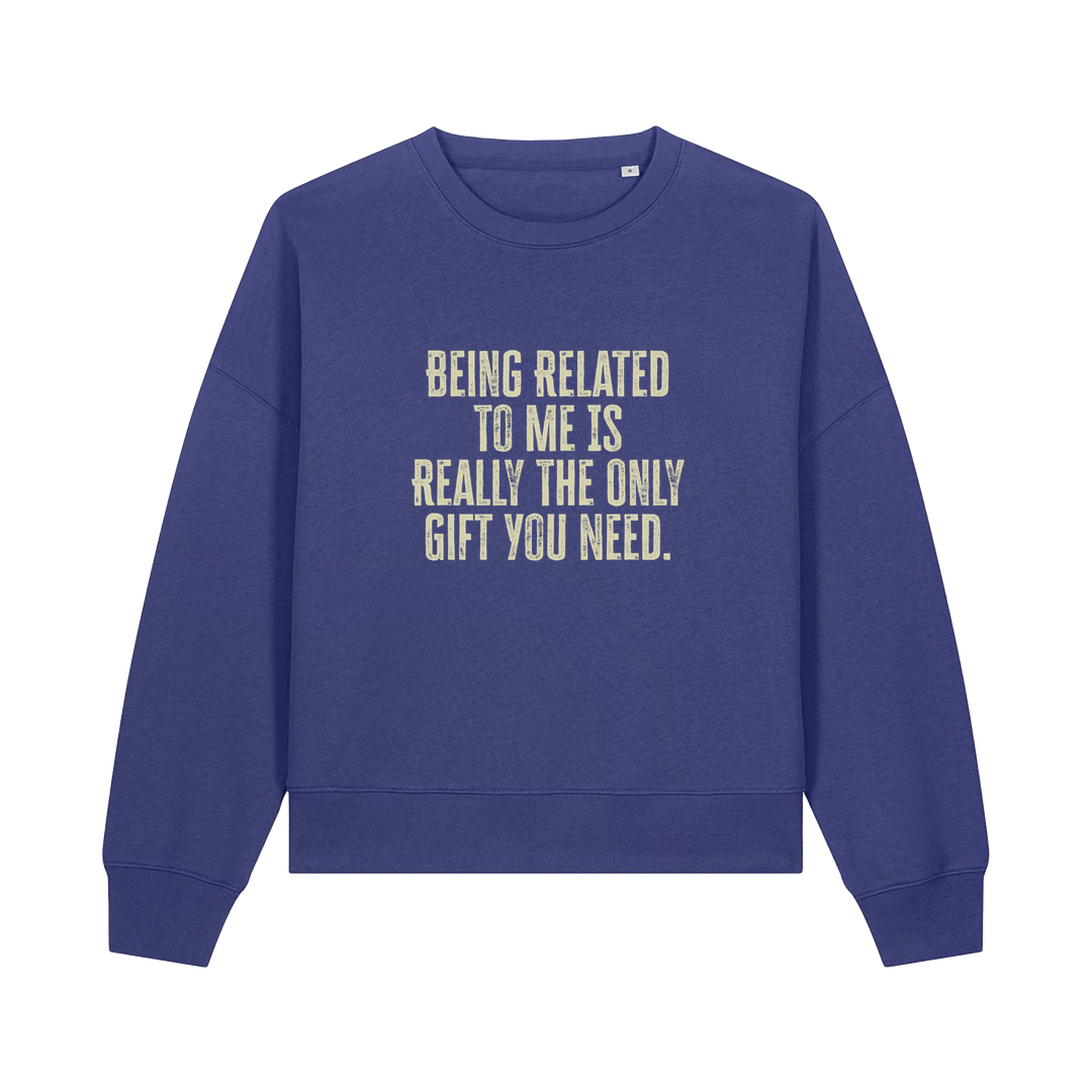 blue christmas sweater with the slogan 'being related to me is really the only gift you need'