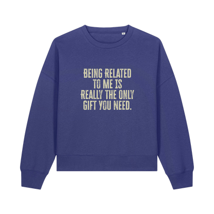 blue christmas sweater with the slogan 'being related to me is really the only gift you need'