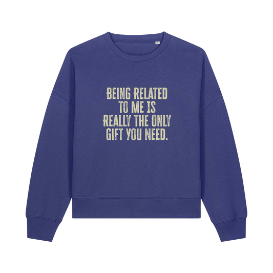 blue christmas sweater with the slogan 'being related to me is really the only gift you need'