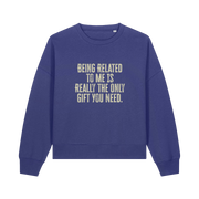 blue christmas sweater with the slogan 'being related to me is really the only gift you need'