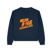 navy christmas sweater with the slogan 'the gobbling' and the graphic of a turkey inside the writing