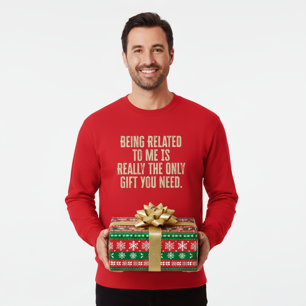 Man wearing a red sweater with humorous text holding a gift box on a white background