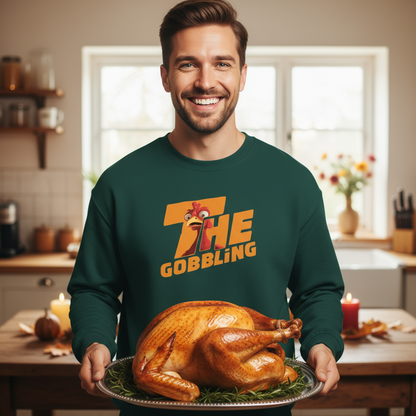 Man holding a roasted turkey in a kitchen wearing a green sweatshirt with 'The Gobbling' design.