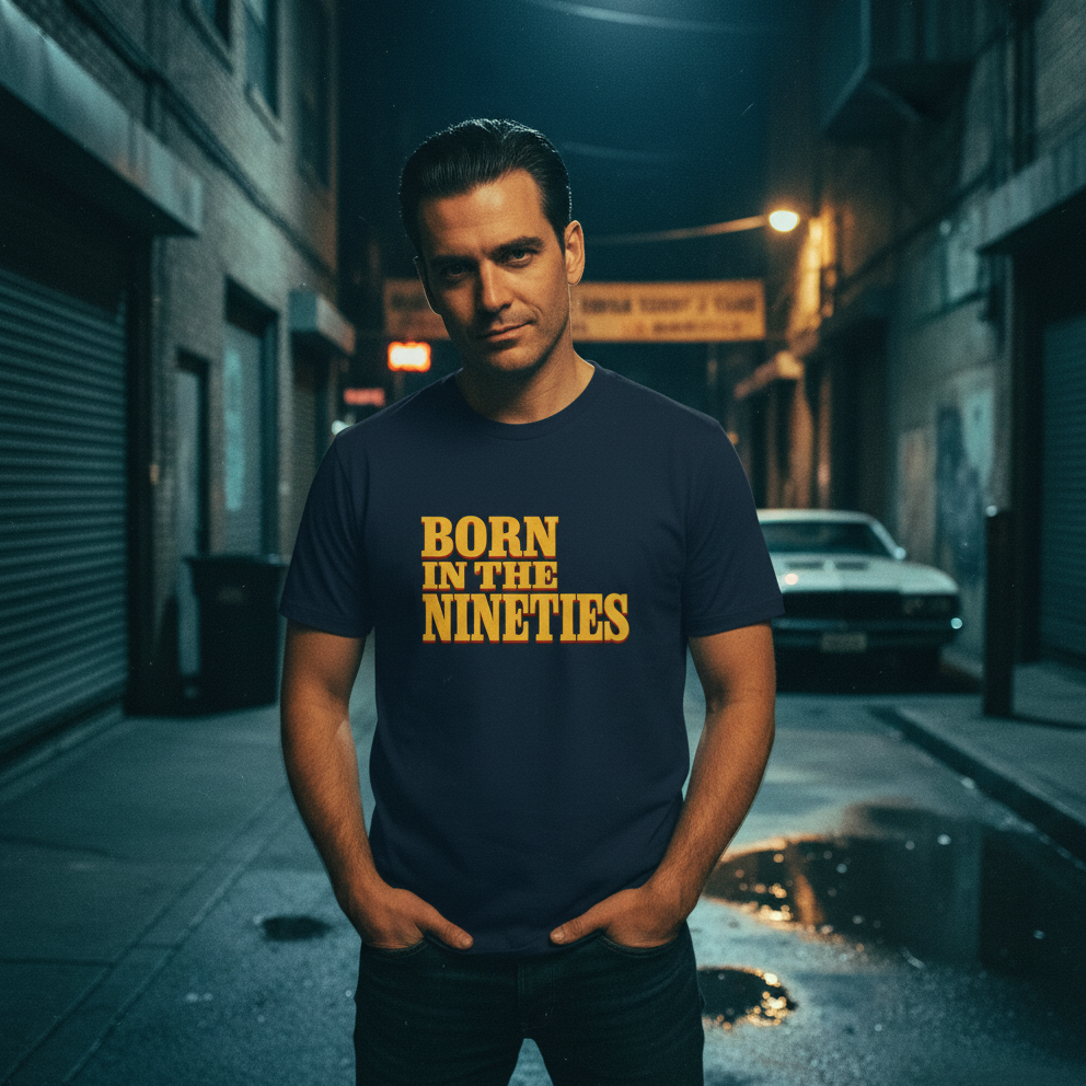 Man wearing a t-shirt with 'Born in the Nineties' text on a street at night.