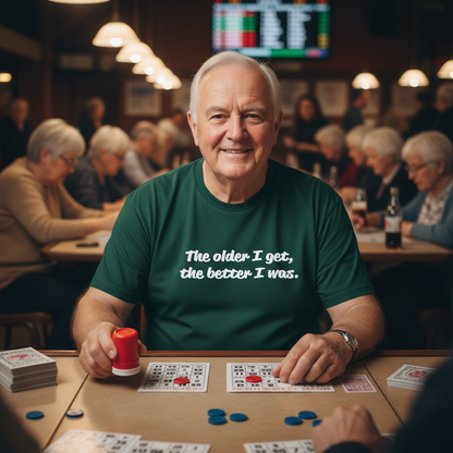Man playing cards in a social setting with a humorous t-shirt message.